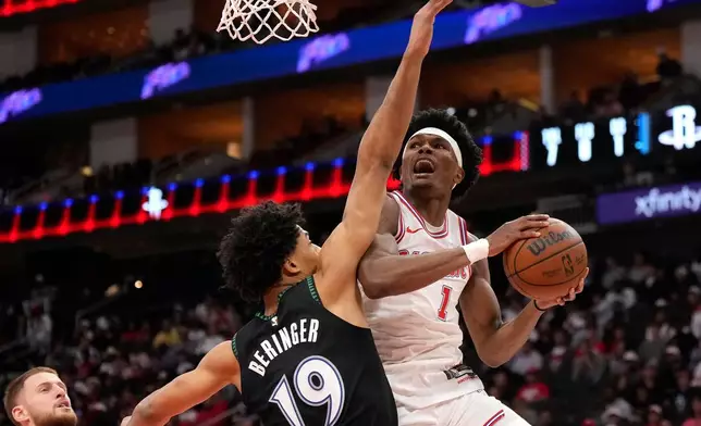 Houston Rockets guard Amen Thompson (1) goes up to the basket against Minnesota Timberwolves center Joan Beringer (19) during the first half of an NBA basketball game, Friday, April 10, 2026, in Houston. (AP Photo/ Karen Warren)