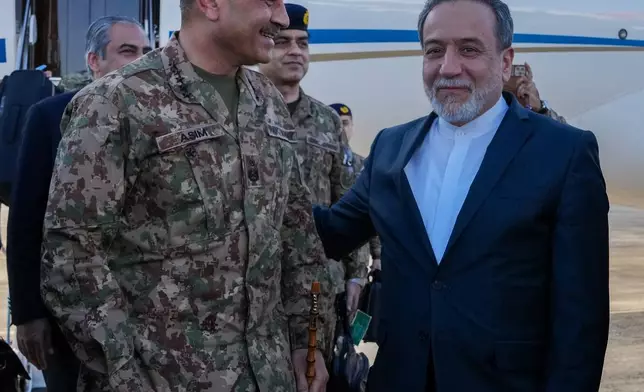 In this photo released by the Iranian Foreign Ministry, Pakistan's Army Chief Field Marshal Gen. Asim Munir, left, is welcomed by Iranian Foreign Minister Abbas Araghchi upon his arrival in Tehran, Wednesday, April 15, 2026. (Iranian Foreign Ministry via AP)