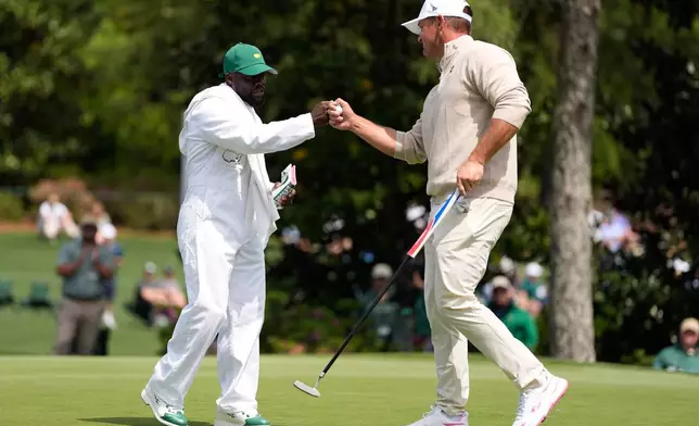 Actor Kevin Hart, left, celebrates with Bryson DeChambeau on the third hole during par-3 contest ahead of the Masters golf tournament at the Augusta National Golf Club, Wednesday, April 8, 2026, in Augusta, Ga. (AP Photo/Ashley Landis)