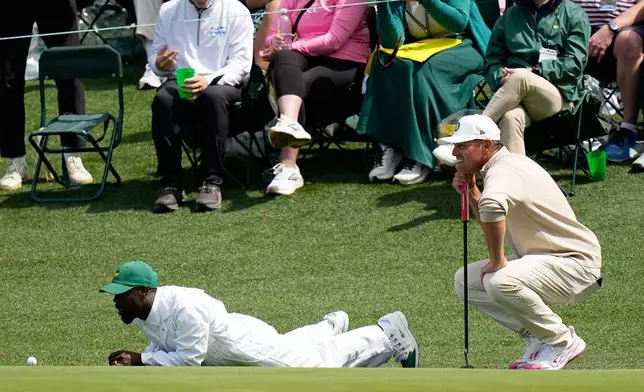 Actor Kevin Hart, left, and Bryson DeChambeau line up a putt during par-3 contest ahead of the Masters golf tournament at the Augusta National Golf Club, Wednesday, April 8, 2026, in Augusta, Ga. (AP Photo/Ashley Landis)