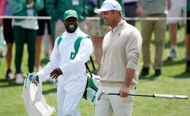 Actor Kevin Hart, left, and Bryson DeChambeau laugh during par-3 contest ahead of the Masters golf tournament at the Augusta National Golf Club, Wednesday, April 8, 2026, in Augusta, Ga. (AP Photo/Ashley Landis)