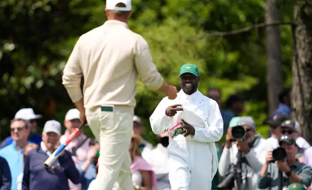 Actor Kevin Hart, right, smiles as Bryson DeChambeau on the second hole during par-3 contest ahead of the Masters golf tournament at the Augusta National Golf Club, Wednesday, April 8, 2026, in Augusta, Ga. (AP Photo/Ashley Landis)