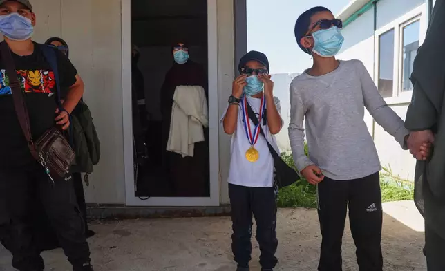 Members of Australian families at Roj Camp in eastern Syria, housing people with alleged ties to Islamic State militants, prepare to leave for Damascus as part of a second repatriation effort by Syrian authorities, at Roj Camp in eastern Syria, Friday, April 24, 2026. (AP Photo/Baderkhan Ahmad)