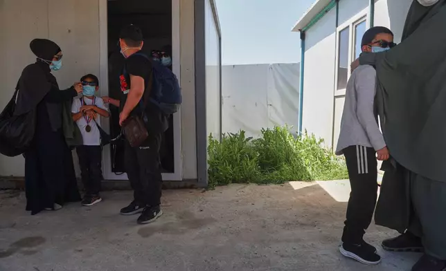 Members of Australian families at Roj Camp in eastern Syria, housing people with alleged ties to Islamic State militants, prepare to leave for Damascus as part of a second repatriation effort by Syrian authorities, Friday, April 24, 2026. (AP Photo/Baderkhan Ahmad)