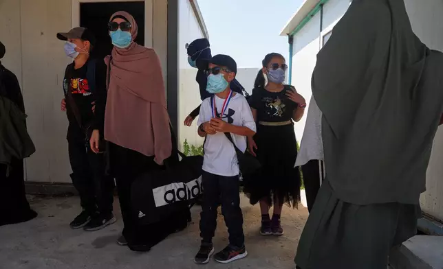 Members of Australian families at Roj Camp in eastern Syria, housing people with alleged ties to Islamic State militants, prepare to leave for Damascus as part of a second repatriation effort by Syrian authorities, at Roj Camp in eastern Syria, Friday, April 24, 2026. (AP Photo/Baderkhan Ahmad)