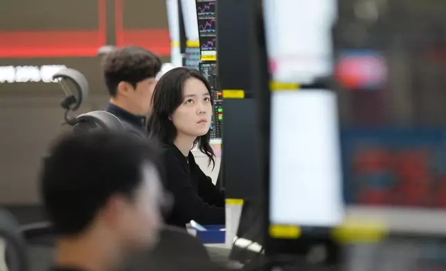 A dealer watches computer monitors at a dealing room of Hana Bank in Seoul, South Korea, Tuesday, April 21, 2026. (AP Photo/Lee Jin-man)