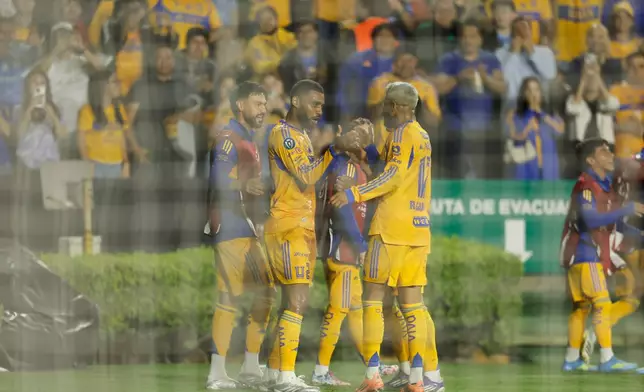 Mexico's Tigres players celebrate after Jackson Ragen of the United States' Seattle Sounders scoring an own goal during a CONCACAF Champions Cup quarterfinal first leg soccer match in Monterrey, Mexico, Wednesday, April 8, 2026. (AP Photo/Jorge Mendoza)