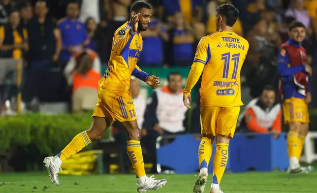Mexico's Tigres players celebrate after Jackson Ragen of the United States' Seattle Sounders scoring an own goal during a CONCACAF Champions Cup quarterfinal first leg soccer match in Monterrey, Mexico, Wednesday, April 8, 2026. (AP Photo/Jorge Mendoza)
