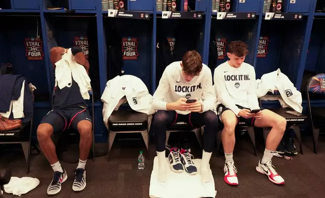 UConn players sit in their locker room after losing to Michigan in the NCAA college basketball tournament national championship game at the Final Four, Monday, April 6, 2026, in Indianapolis. (AP Photo/AJ Mast)