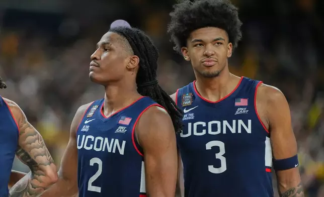UConn's Silas Demary Jr. (2) and Jaylin Stewart reactsafter losing to Michigan in the NCAA college basketball tournament national championship game at the Final Four, Monday, April 6, 2026, in Indianapolis. (AP Photo/Michael Conroy)