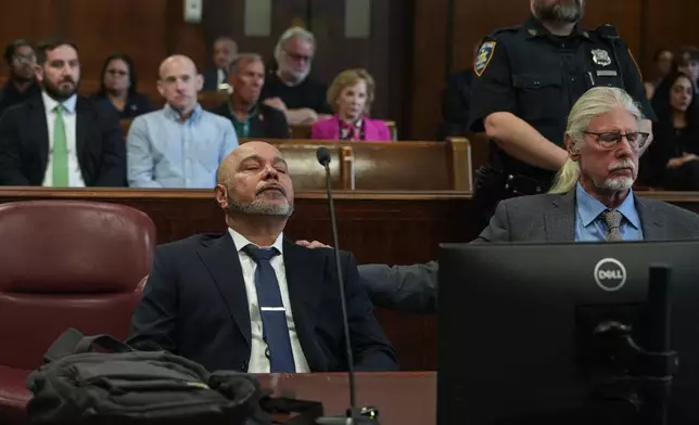 Harry Ruiz sits in a New York City courtroom with his lawyer, Ron Kuby, as a judge prepares to vacate his murder conviction on Monday, April 27, 2026. (Dean Moses/amNewYork via AP, Pool)
