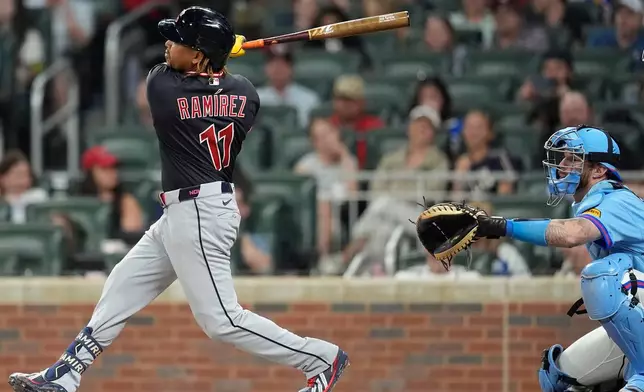 Cleveland Guardians' José Ramírez (11) hits a single in the sixth inning of a baseball game against the Atlanta Braves, Saturday, April 11, 2026, in Atlanta. (AP Photo/Mike Stewart)