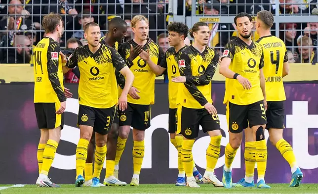Dortmund's Serhou Guirassy, third from left, celebrates with teammates after scoring his side's second goal during the German Bundesliga soccer match between Borussia Dortmund and SC Freiburg in Dortmund, Germany, Sunday, April 26, 2026. (AP Photo/Martin Meissner)