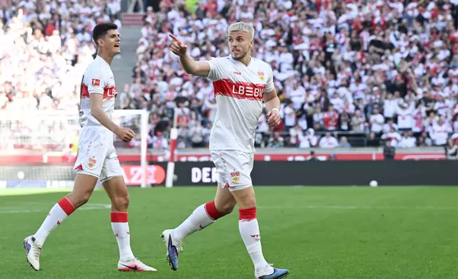 Stuttgart's Ermedin Demirovic, right, celebrates after scoring his side's first goal during the German Bundesliga soccer match between VfB Stuttgart and Werder Bremen in Stuttgart, Germany, Sunday, April 26, 2026. (Bernd Weissbrod/dpa via AP)