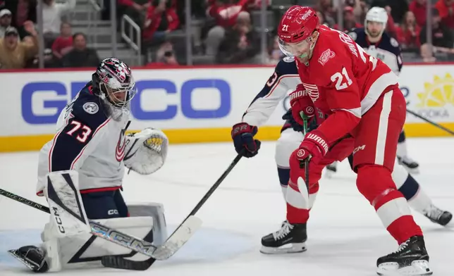 Columbus Blue Jackets goaltender Jet Greaves (73) stops a Detroit Red Wings left wing James van Riemsdyk (21) shot in the second period of an NHL hockey game Tuesday, April 7, 2026, in Detroit. (AP Photo/Paul Sancya)