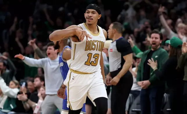 Boston Celtics forward Ron Harper Jr. (13) reacts after scoring during the second half of an NBA basketball game against Orlando Magic, Sunday, April 12, 2026, in Boston. (AP Photo/Mark Stockwell)