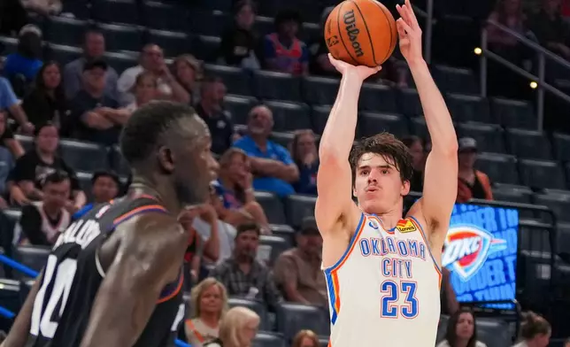 Oklahoma City Thunder forward Brooks Barnhizer, right, shoots over Phoenix Suns forward Khaman Maluach during the second half of an NBA basketball game, Sunday, April 12, 2026, in Oklahoma City. (AP Photo/Kyle Phillips)