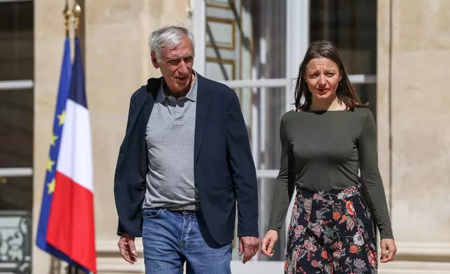 Jacques Paris, left, and Cecile Kohler, French nationals who were freed by Iran with after three and a half years in detention, walk at the Elysee Palace as they are hosted by French President Emmanuel Macron, in Paris, France, April 8, 2026. (Tom Nicholson/Pool Photo via AP)