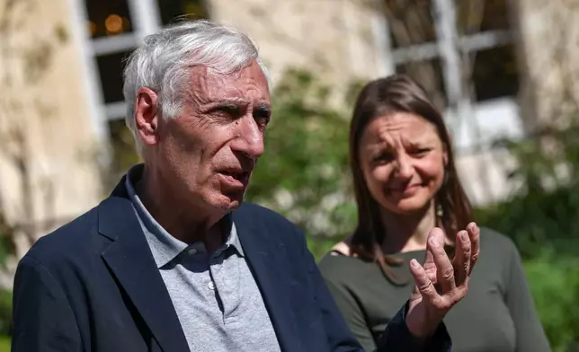 Jacques Paris, left, and Cecile Kohler, French nationals who were freed by Iran with after three and a half years in detention, speak to media at the Elysee Palace as they are hosted by French President Emmanuel Macron, in Paris, France, April 8, 2026. (Tom Nicholson/Pool Photo via AP)
