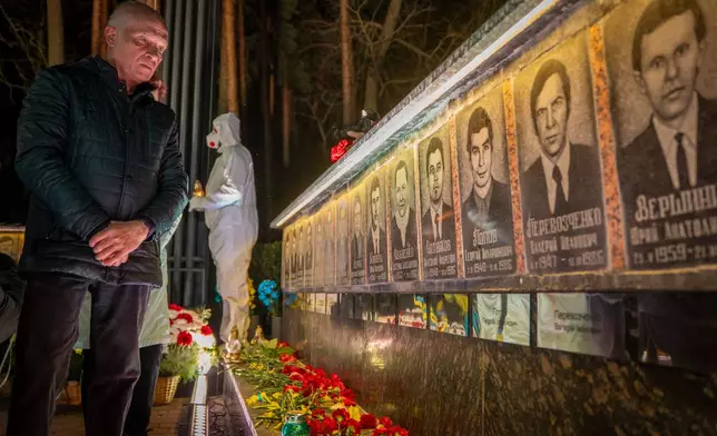 A man looks at a memorial dedicated to firefighters and workers who died after the 1986 Chornobyl (Chernobyl) nuclear disaster, ahead of its 40th anniversary in Slavutych, Ukraine, Saturday, April 25, 2026. Chornobyl is the Ukrainian name for the city. (AP Photo/Dan Bashakov)