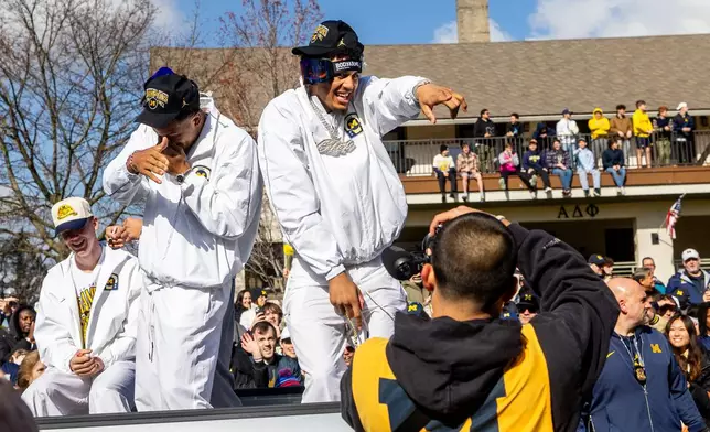 Michigan forward Yaxel Lendeborg , left, and Trey McKenney celebrate during a parade celebrating their national championship win in the NCAA college basketball tournament , Saturday, April 11, 2026, in Ann Arbor, Mich. ( Devin Anderson-Torrez/Ann Arbor News via AP)