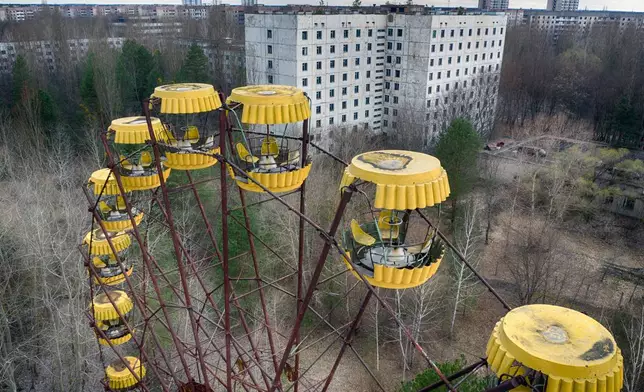 FILE - An abandoned Ferris wheel stands in a city park, April 15, 2021, in the abandoned town of Pripyat, Ukraine, once home to workers and their families whose lives were connected to the nearby Chernobyl nuclear power plant. (AP Photo/Efrem Lukatsky, File)