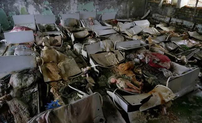 FILE - Beds sit in a room of an abandoned kindergarten in the deserted town of Pripyat, Ukraine, Nov. 27, 2012, which housed Chernobyl nuclear power plant workers and their families. (AP Photo/Efrem Lukatsky, File)