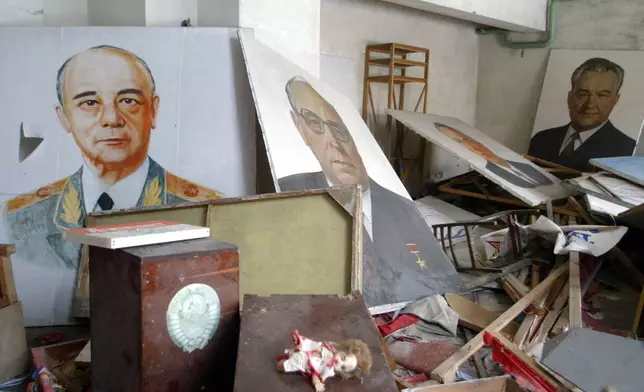 FILE - Portraits of Soviet officials covered by radioactive dust sit in a city club in Pripyat, Ukraine, April 10, 2006, where Chernobyl nuclear power plant workers lived and were evacuated after the deadly explosion and fire. (AP Photo/Efrem Lukatsky, File)