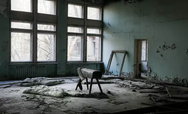 FILE - A pommel horse sits in a school gymnasium in the deserted town of Pripyat, Ukraine, April 5, 2017, once home to people whose lives were connected to the nearby Chernobyl nuclear power plant. (AP Photo/Efrem Lukatsky, File)