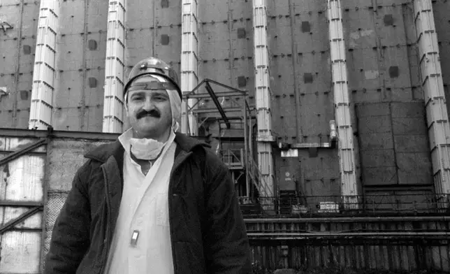 FILE - Efrem Lukatsky, now an Associated Press photographer, wears protective clothes outside the sarcophagus that covers destroyed Reactor No. 4 in the Chernobyl nuclear power plant in Chernobyl, Ukraine, in this undated photo taken several years after the explosion. (AP Photo, File)