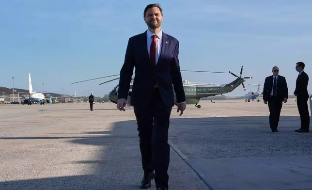 Vice President JD Vance walks to speak with the Press before boarding Air Force Two, Friday, April 10, 2026, at Joint Base Andrews, Md., for expected departure to Pakistan, for talks on Iran. (AP Photo/Jacquelyn Martin, pool)