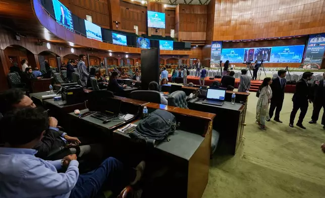 Members of the media work at a media center setup for the coverage of the US-Iran talks, in Islamabad, Pakistan, Saturday, April 11, 2026. (AP Photo/Anjum Naveed)