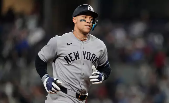 New York Yankees' Aaron Judge rounds the bases after hitting a solo home run in the third inning of a baseball game against the Texas Rangers Monday, April 27, 2026, in Arlington, Texas. (AP Photo/Tony Gutierrez)