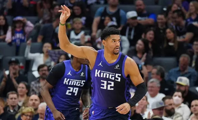Sacramento Kings center Dylan Cardwell (32) gestures after making a basket during the first half of an NBA basketball game against the New Orleans Pelicans, Friday, April 3, 2026, in Sacramento, Calif. (AP Photo/Alan Greth)