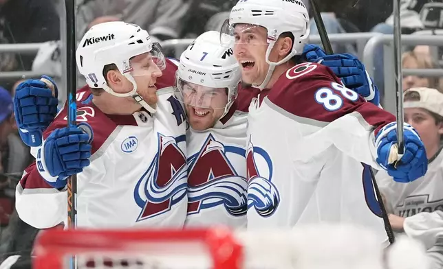 Colorado Avalanche's Devon Toews (7) celebrates his goal with Nathan MacKinnon (29) and Martin Necas (88) against the Los Angeles Kings during the third period of Game 4 in the first round of an NHL hockey Stanley Cup playoff series Sunday, April 26, 2026, in Los Angeles. (AP Photo/Scott Strazzante)