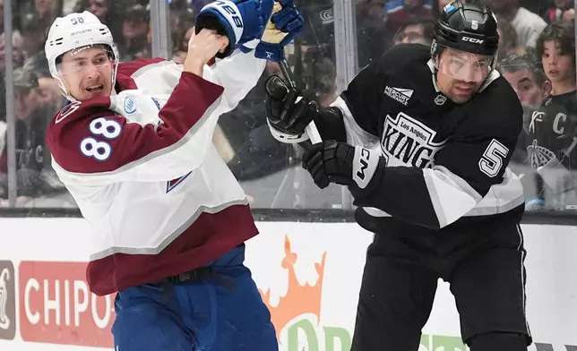 Colorado Avalanche's Martin Necas (88) and Los Angeles Kings' Cody Ceci (5) chase the puck during the first period of Game 4 in the first round of an NHL hockey Stanley Cup playoff series Sunday, April 26, 2026, in Los Angeles. (AP Photo/Scott Strazzante)