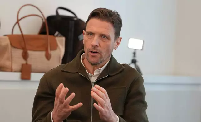 James Ferragamo, Men's and Women's Leather Product Director for the Salvatore Ferragamo group, talks with journalist during an interview with Associated Press in Milan, Italy, Wednesday, April 22, 2026. (AP Photo/Antonio Calanni)