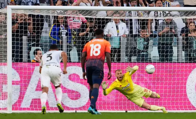 Juventus' goalkeeper Michele Di Gregorio saves a penalty kick during the Italian Serie A soccer match between Juventus and Genoa in Turin, Italy, Monday, April 6, 2026. (Fabio Ferrari/LaPresse via AP)