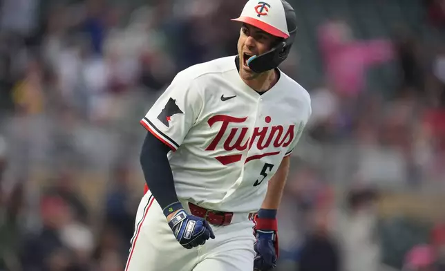 Minnesota Twins' Ryan Kreidler (5) celebrates after hitting a solo home run during the second inning of a baseball game against the Boston Red Sox Monday, April 13, 2026, in Minneapolis. (AP Photo/Abbie Parr)