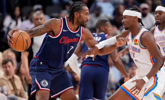 Los Angeles Clippers forward Kawhi Leonard, left, tries to get by Oklahoma City Thunder guard Shai Gilgeous-Alexander during the first half of an NBA basketball game Wednesday, April 8, 2026, in Inglewood, Calif. (AP Photo/Mark J. Terrill)