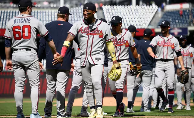 Atlanta Braves' Ronald Acuna Jr., center, celebrates with JR Ritchie (60) and others after a baseball game against the Washington Nationals, Thursday, April 23, 2026, in Washington. (AP Photo/Nick Wass)