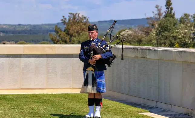 A British soldier plays a pipe during a ceremony in recognition of the fallen during Gallipoli campaign, at the Cape Helles British memorial site in the Gallipoli peninsula near Canakkale, Turkey, Friday, April 24, 2026. (Sercan Ozkurnazli/Dia Photo via AP)