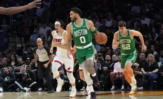 Boston Celtics forward Jayson Tatum (0) moves down the court during the first half of an NBA basketball game against the Miami Heat, Wednesday, April 1, 2026, in Miami. (AP Photo/Lynne Sladky)