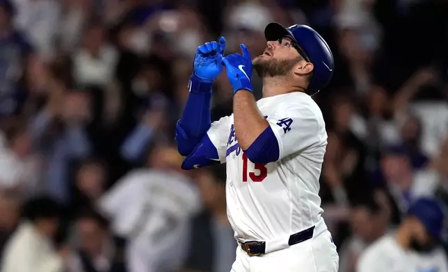 Los Angeles Dodgers' Max Muncy gestures after hitting a solo home run during the forth inning of a baseball game against the Texas Rangers, Friday, April 10, 2026, in Los Angeles. (AP Photo/Mark J. Terrill)