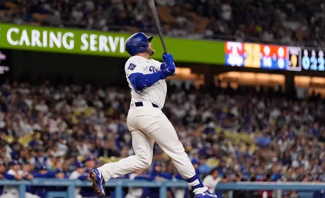 Los Angeles Dodgers' Max Muncy hits a walk off solo home run during the ninth inning of a baseball game against the Texas Rangers, Friday, April 10, 2026, in Los Angeles. (AP Photo/Mark J. Terrill)