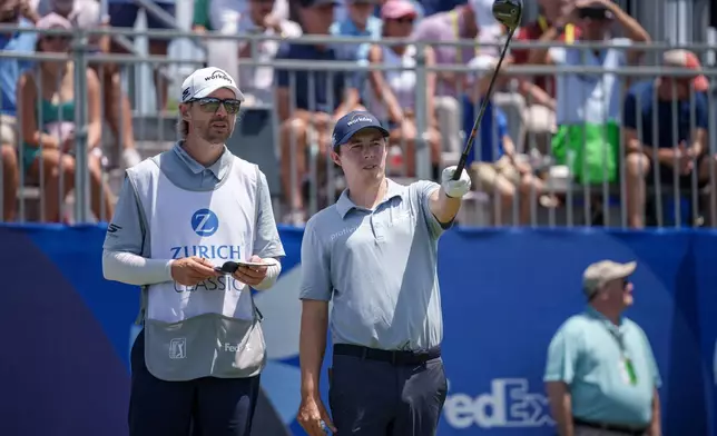 Matt Fitzpatrick, of England, talks with his caddie before teeing off on the first hole during the first round of the PGA Zurich Classic golf tournament, Thursday, April 23, 2026, in Avondale, La. (AP Photo/Matthew Hinton)