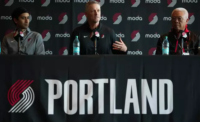 Portland Trail Blazers new owner and governor Tom Dundon, center, speaks as alternate governors Andrew Cherng, right, and Sheel Tyle listen during a news conference on Thursday, April 2, 2026, in Portland, Ore. (AP Photo/Jenny Kane)