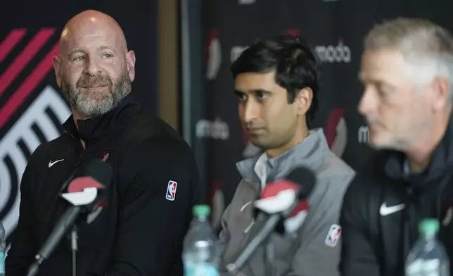 Portland Trail Blazers general manager Joe Cronin, left, and Sheel Tyle, Blazers alternate governor, center, listen as during a news conference with new owner and governor Tom Dundon, right, on Thursday, April 2, 2026, in Portland, Ore. (AP Photo/Jenny Kane)