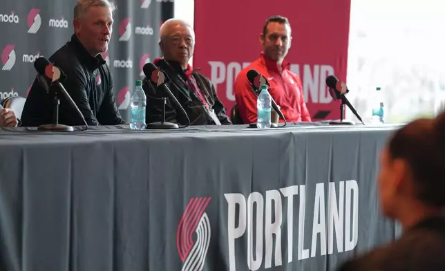 Portland Trail Blazers new owner and governor Tom Dundon, left, speaks during a news conference on Thursday, April 2, 2026, in Portland, Ore. (AP Photo/Jenny Kane)
