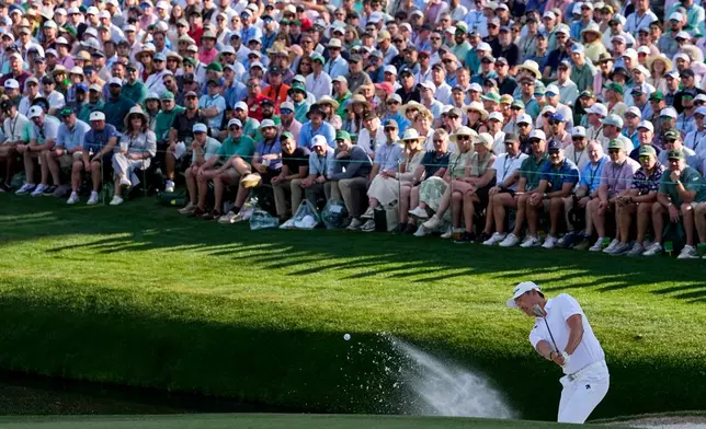 Haotong Li, of China, hits from the bunker on the 16th hole during the final round of the Masters golf tournament at the Augusta National Golf Club, Sunday, April 12, 2026, in Augusta, Ga. (AP Photo/Gerald Herbert)